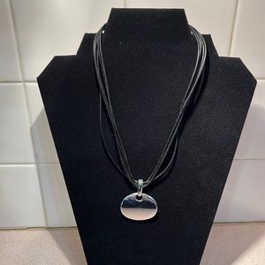 Silver oval pendant on black rope necklace